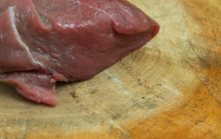 Raw beef meat on wood backgroundの写真素材