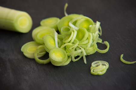 close up on fresh leek on dark rock backgroundの写真素材