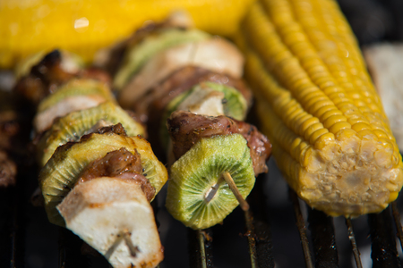 close on raw meat with fruits on the grillの写真素材
