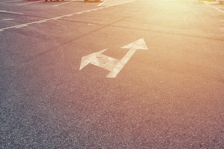 left and forward arrow on the streer with sunrise lightの写真素材