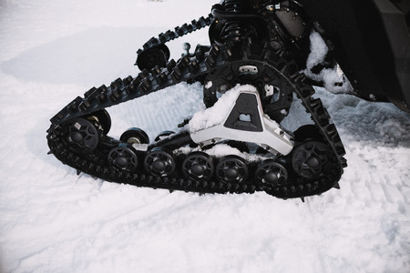 close up on ratrak wheels on the snowの写真素材