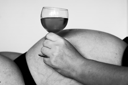 pregnant woman drinks alcohol - wine, black and whiteの写真素材
