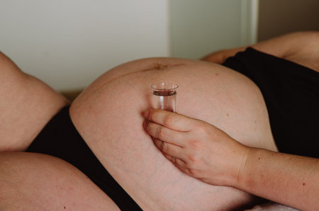 pregnant woman drinks alcohol - vodkaの写真素材