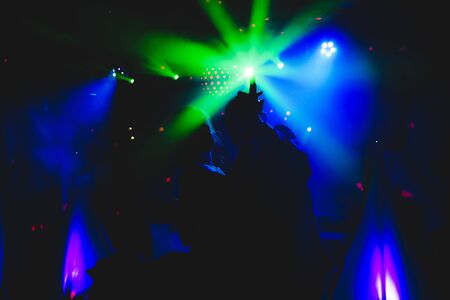 dancing in the club with strong lightsの写真素材