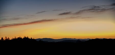 sunrise on the meadow with hills in backgroundの写真素材
