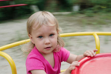 baby girl playing in the children playgroundの写真素材
