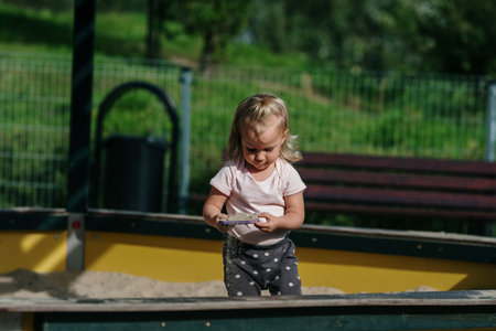 young blonde girl have fun on Children's Playgroundの写真素材