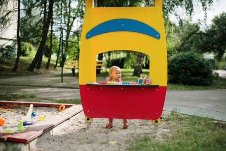 baby girl playing in the children playgroundの写真素材