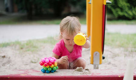 baby girl playing in the children playgroundの写真素材