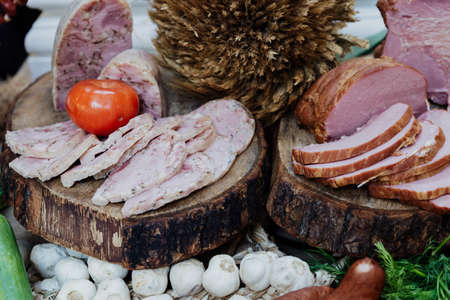 village table - ham, headcheese and sausage on woodの写真素材