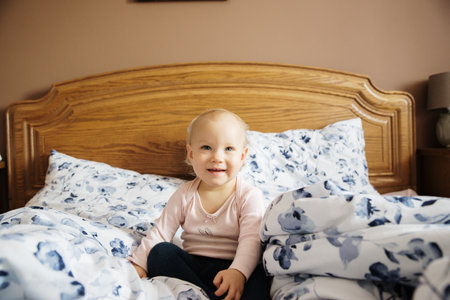 baby girl in the parents bedの写真素材