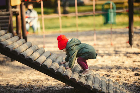 baby girl on playground, fallの写真素材
