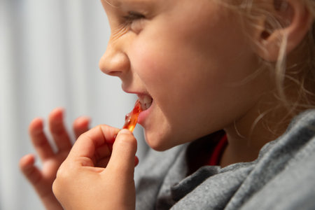 the girl is eating jellyの写真素材
