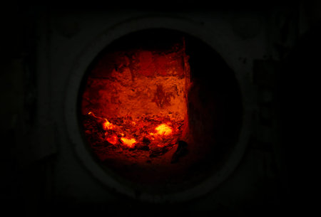 brick furnace with fire and ember, round door