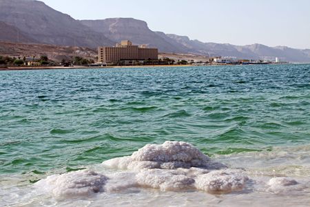 The coastline of the Dead Sea hotels and salt crystals   の写真素材