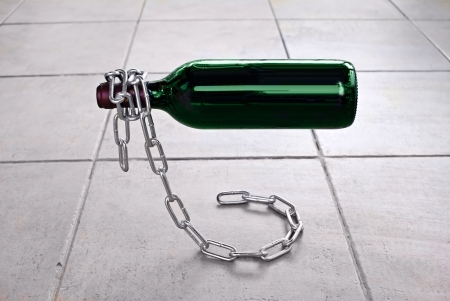Bottle of wine on the original base in the form of a chainの写真素材