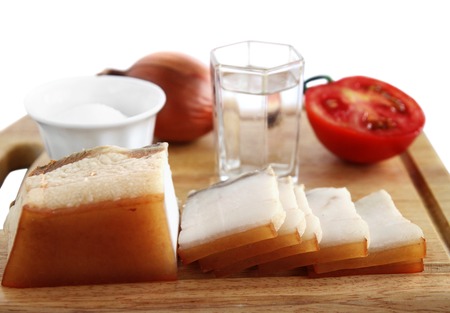 bacon, onion, tomato and glass of vodka on a white backgroundの写真素材