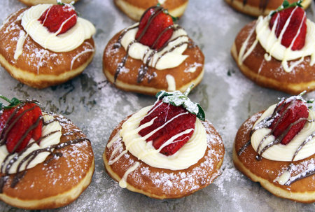 Hanukkah donuts decorated with fresh strawberries and creamの写真素材
