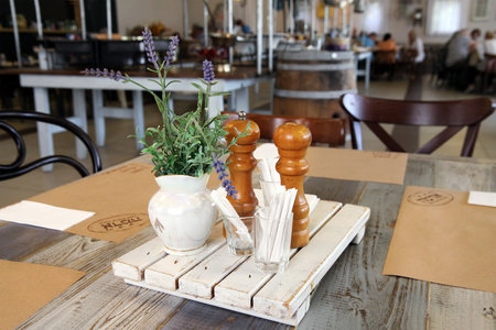 KIBBUTZ SNIR, ISRAEL - MAY 27, 2015: The interior of the dining room of the kibbutz in a rustic style with a bouquet of  lavenderのeditorial素材