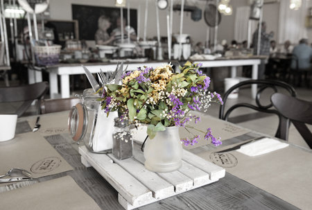 KIBBUTZ SNIR, ISRAEL - MAY 27, 2015: Table setting in a rustic style with a bouquet of  dry flowersのeditorial素材
