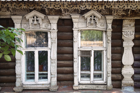 PENZA, RUSSIA - AUGUST 15, 2012: The facade of the old wooden houses with carved architraves 19th century Penzaのeditorial素材