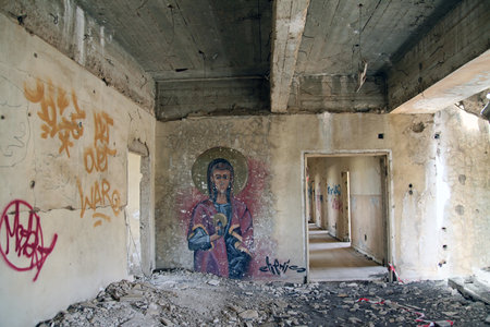 QUNEITRA, SYRIA - MARCH 27, 2015: Abandoned city of Quneitra. This building was the headquarters of Syrian ground forces before the Yom Kippur War. Graffiti on the wallのeditorial素材