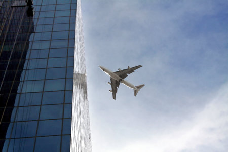 TEL AVIV, ISRAEL - FEBRUAR 12, 2010: Passenger plane flying over the city near the skyscraperのeditorial素材