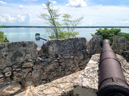 Ancient cannon on the wall of the fort of San Felipe in Bacalar Lagoon, Mexicoの写真素材