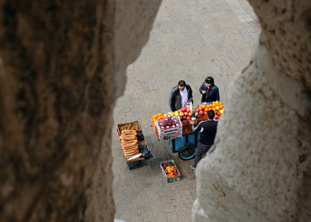 JERUSALEM, ISRAEL - MARCH 25, 2017: View through a loophole Jaffa Gate of the Old Town to the seller of juices and buyersのeditorial素材