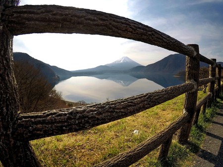 View of Mount Fujiyama through a wooden fenceの写真素材
