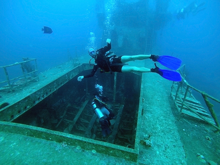 Divers inspect a flooded ship in the Red Seaの写真素材