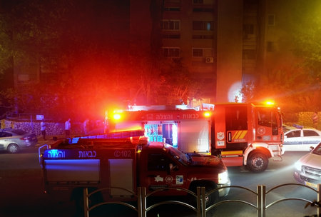 BEER SHEVA, ISRAEL - JUNE 21, 2017: Extinguishing the fire at night in a residential building. Inscription: fire fighting and rescueのeditorial素材