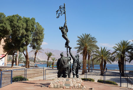 EILAT, ISRAEL - MARCH 06, 2019: Group of fighters raises the flag of the victory of Israel in the War of Independence on the Eilat Embankmentのeditorial素材
