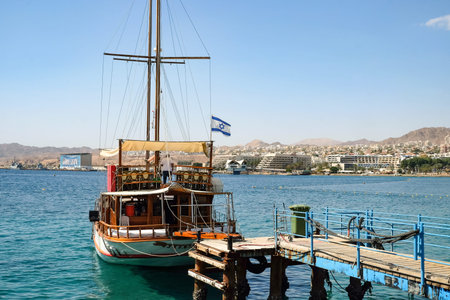 EILAT, ISRAEL - MARCH 03, 2019: Pleasure yacht at the pier in Eilat and view of the waterfront