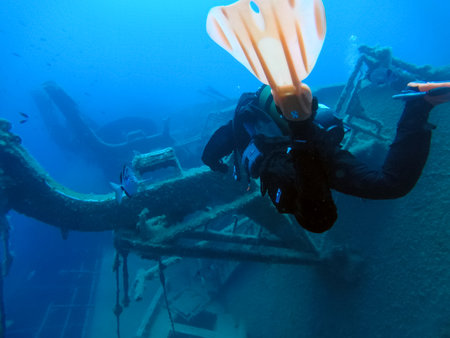 LARNAKA, CYPRUS - MAY 11, 2019: Diver swims underwater next to the sunken Swedish ferry Zenobia in the Mediterraneanのeditorial素材