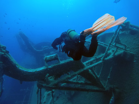 LARNAKA, CYPRUS - MAY 11, 2019: Diver swims underwater next to the sunken Swedish ferry Zenobia in the Mediterraneanのeditorial素材