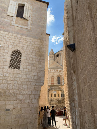 JERUSALEM, ISRAEL - OCTOBER 24, 2019: Group of tourists in front of the Benedictine monastery of...
