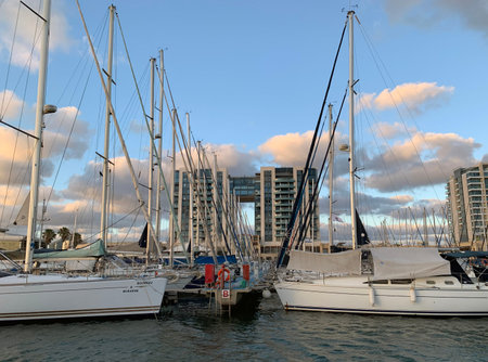 Reflection of yachts and clouds in the water during sunset