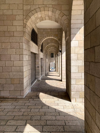JERUSALEM, ISRAEL - MARCH 08, 2021: Gallery along the side facade of the Papal Center Notre Dame Jerusalem next to the walls of the Old Cityのeditorial素材