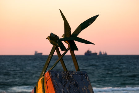 ASHDOD, ISRAEL - SEPTEMBER 18, 2021: Two seagulls - urban sculpture on the beach at sunsetのeditorial素材