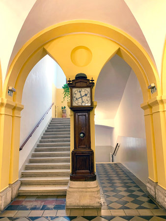JERUSALEM, ISRAEL - DECEMBER 28, 2021: Staircase to the second floor and an old clock in the...