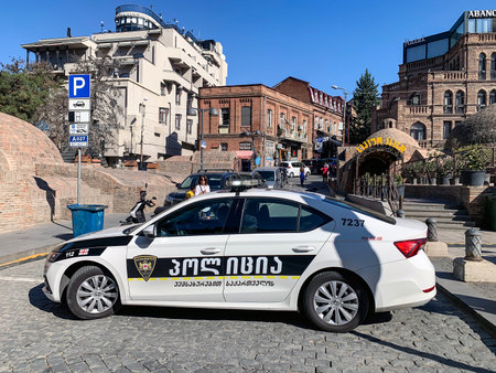 TBILISI, GEORGIA - OCTOBER 01, 2022: Police car with inscriptions in Georgian in the city of Tbilisiのeditorial素材
