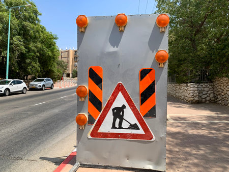 BEER SHEVA, ISRAEL - AUGUST 12, 2022: Road works sign on city streetのeditorial素材