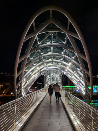 TBILISI, GEORGIA - SEPTEMBER 30, 2022: Night view of the new high-tech bridge across the Kura Riverのeditorial素材
