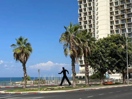 TEL AVIV, ISRAEL - OCTOBER 03, 2023: Urban sculpture of a walking man on the Tel Aviv waterfrontのeditorial素材