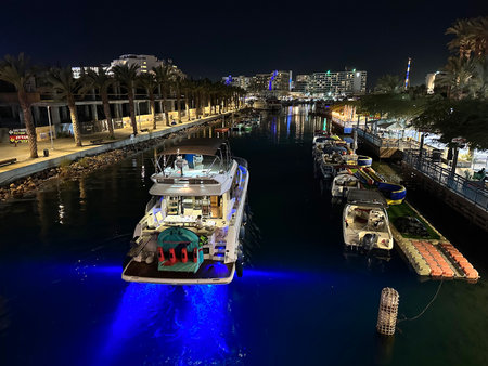 EILAT, ISRAEL - OCTOBER 26, 2023: Passage of a yacht through the canal to the marina in the eveningのeditorial素材