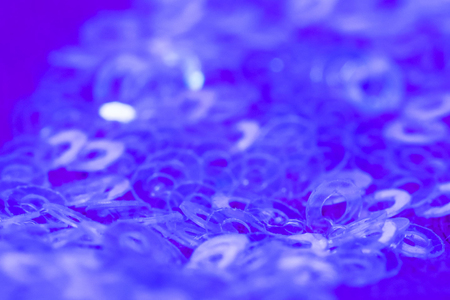 Close-up of transparent sequins on blue fabric Iの写真素材