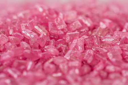 Closeup of a pile of pink sugar crystals (cake decor), side viewの写真素材