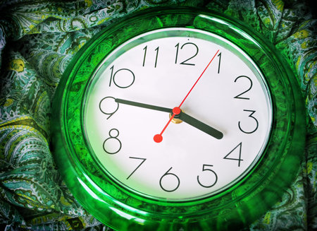 Green clock shows 15:45 (3:45 pm)の写真素材