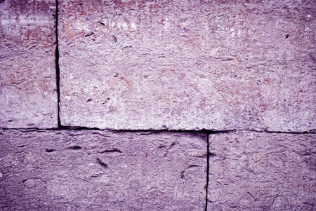 Rough texture of purple stone wall